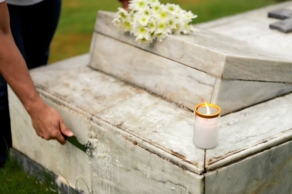 Man Cleaning a Tombstone